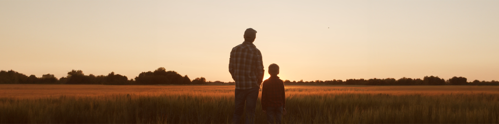 dad and son in a field